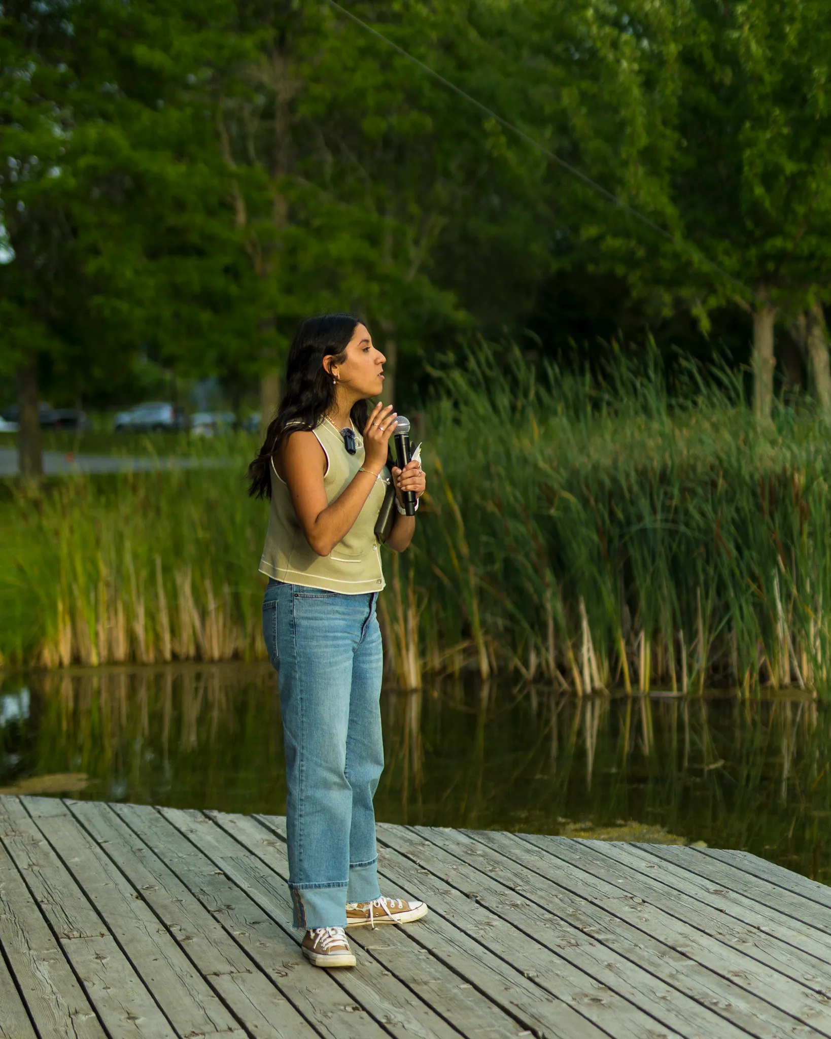 Victoria preaching outdoors beside a pond
