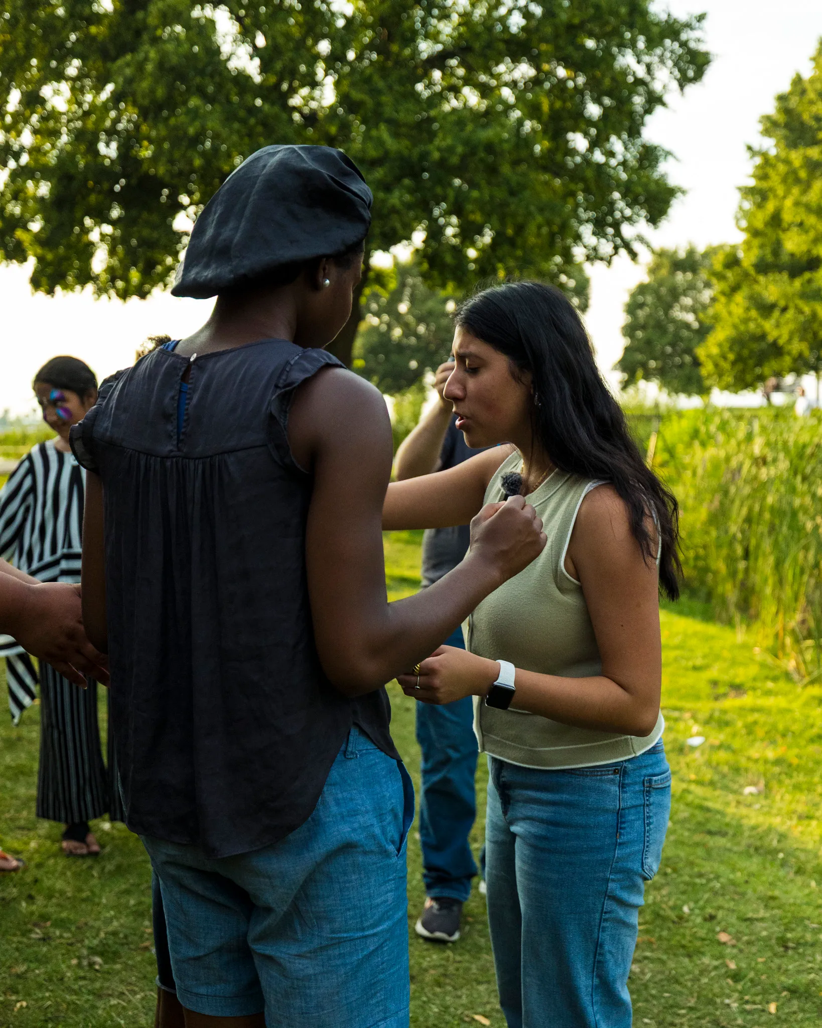 Praying for a woman at an outdoor revival gathering